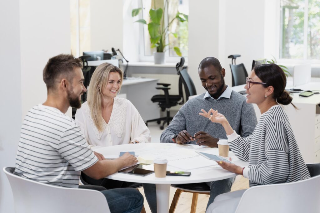 Young team communicating at table in office